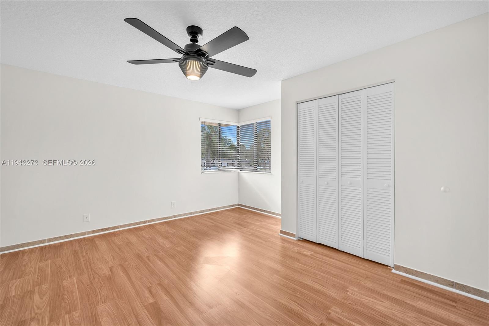 1618 Northwest 81st Way, Unit 1618 Plantation, FL 33322 - Photo 31 of 38 a view of an empty room with wooden floor and a window