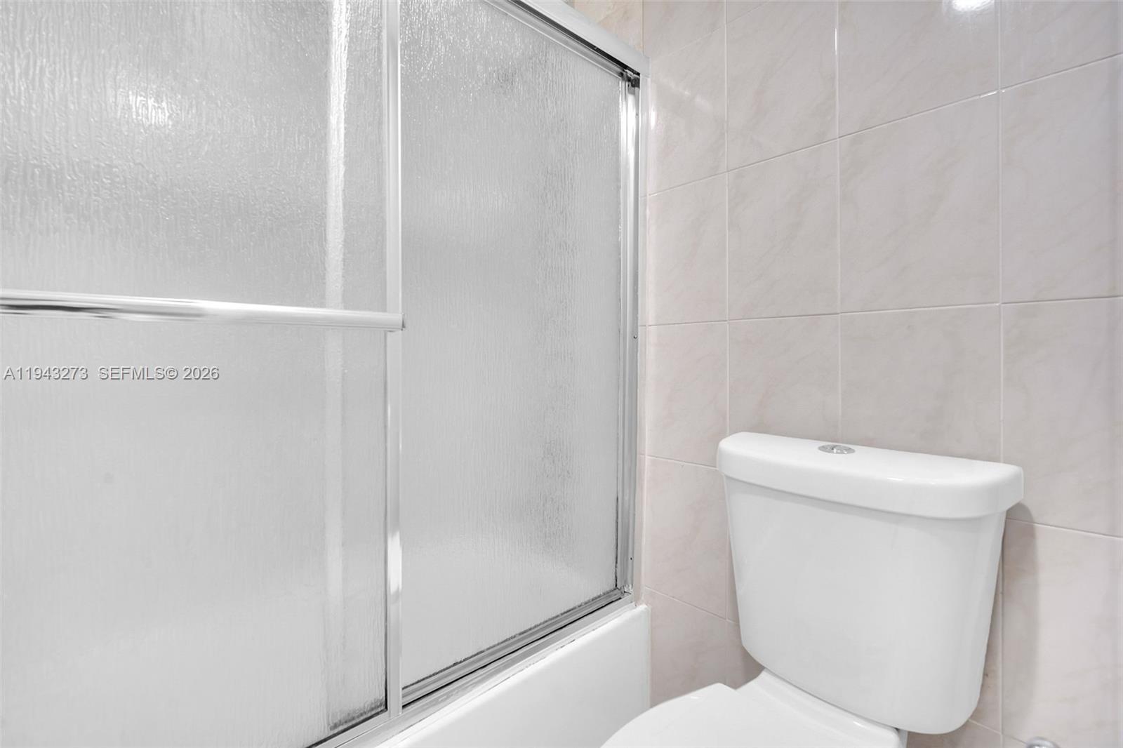 1618 Northwest 81st Way, Unit 1618 Plantation, FL 33322 - Photo 33 of 38 a white toilet sitting next to a bathroom sink