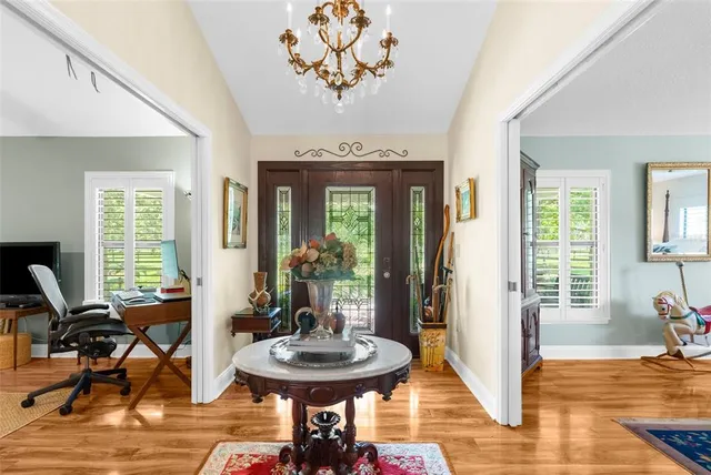 a spacious bathroom with a sink a mirror a bathtub and next to a window