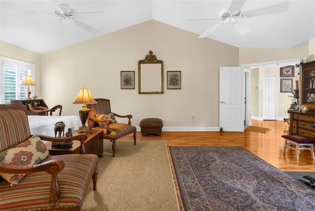 a view of a patio with table and chairs potted plants with wooden floor and fence