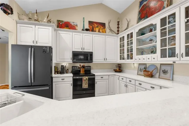 a view of a dining room with furniture and chandelier