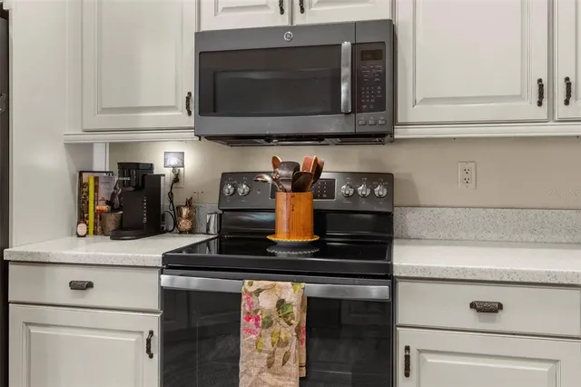 a view of a dining room with furniture a chandelier and wooden floor