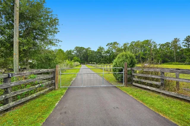 a front view of a house with a garden and yard