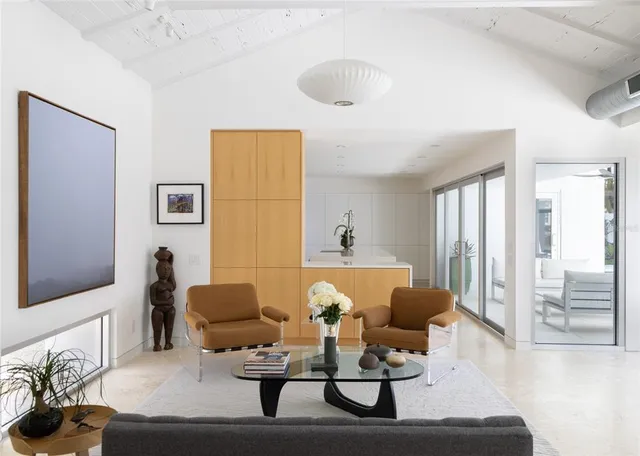 a living room with furniture and a painting on the wall