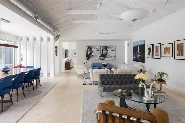 a dining room with a wooden table and chairs