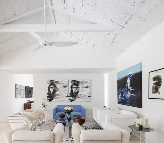 a living room with furniture and a book shelf