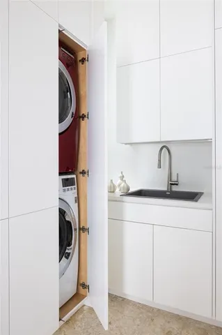 a palm tree sitting in front of a house with a potted plant