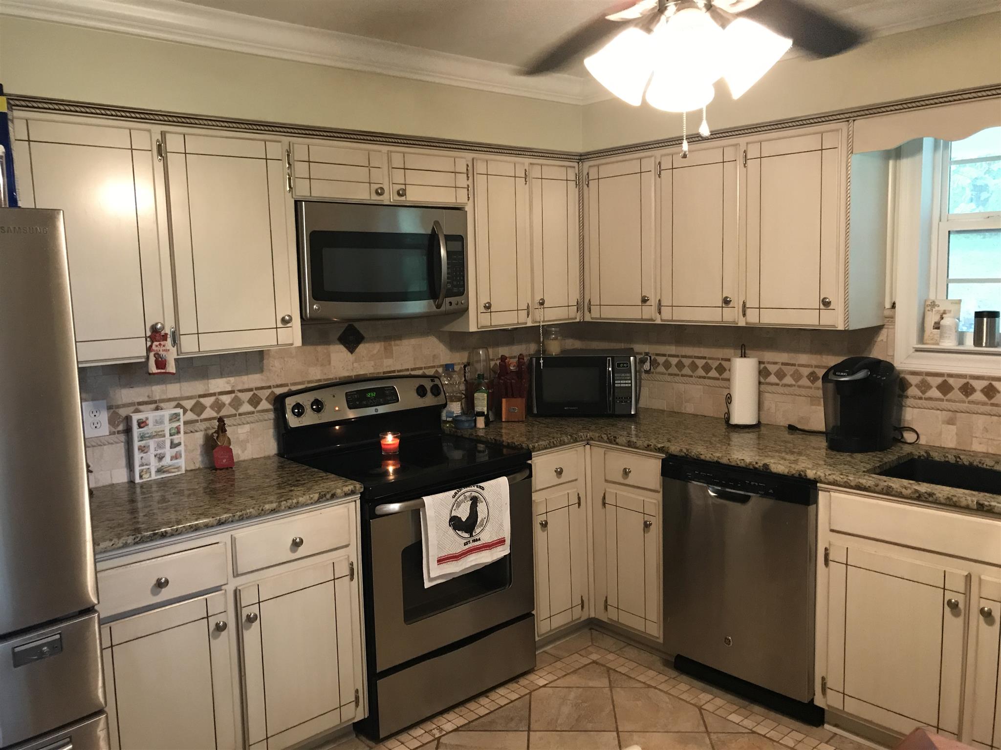 8174 New Chapel Road Springfield, TN 37172 - Photo 11 of 14 a kitchen with stainless steel appliances granite countertop a sink and cabinets