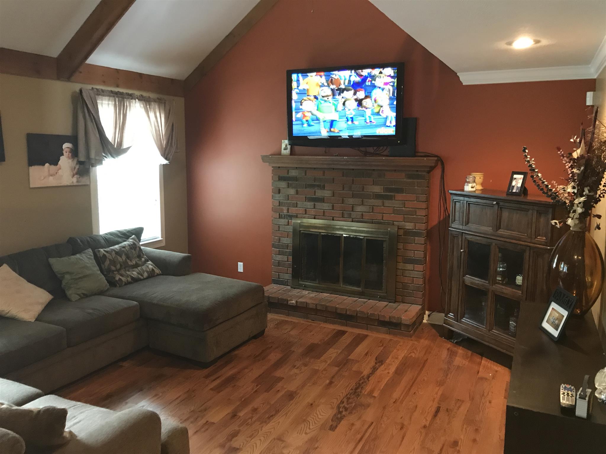 8174 New Chapel Road Springfield, TN 37172 - Photo 9 of 14 a living room with furniture a flat screen tv and a fireplace