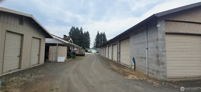 a view of a house with wooden fence and two windows