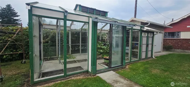 a view of a house with a large window and a yard