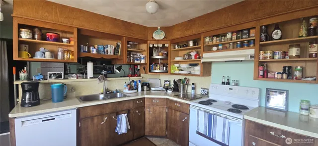 a kitchen with stainless steel appliances granite countertop a sink and cabinets