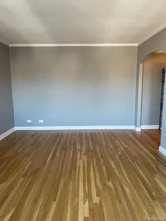 a view of a room with wooden floor