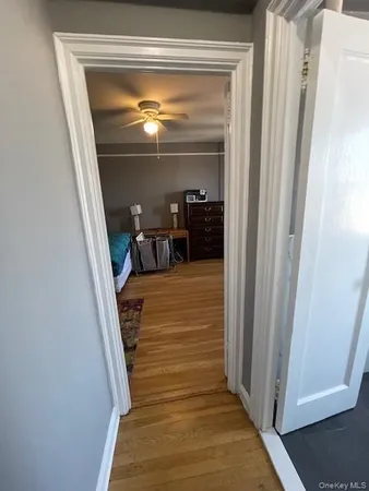 a view of a hallway with wooden floor and staircase