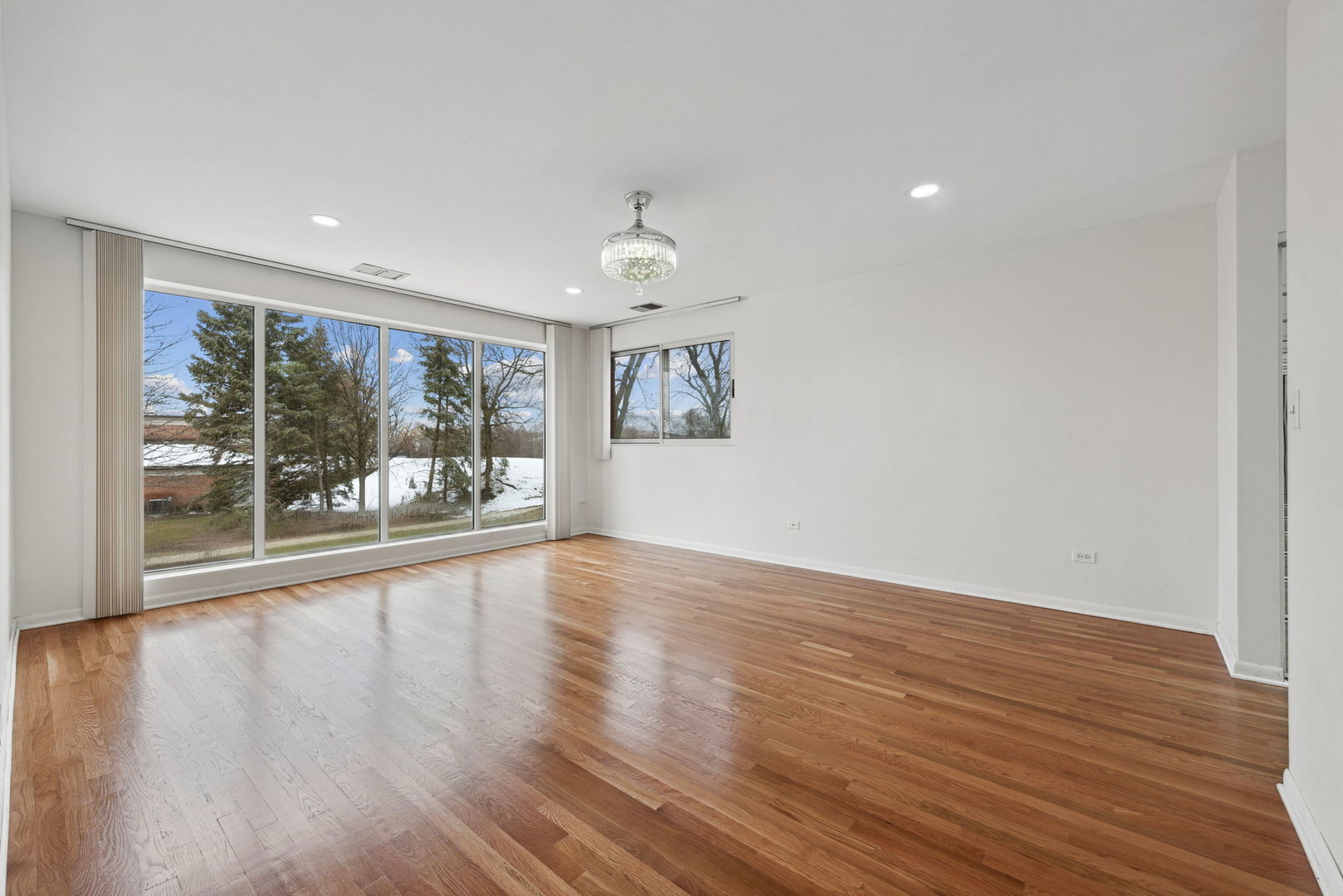 357 Milford Road Deerfield, IL 60015 - Photo 15 of 31 a view of an empty room with wooden floor and a window