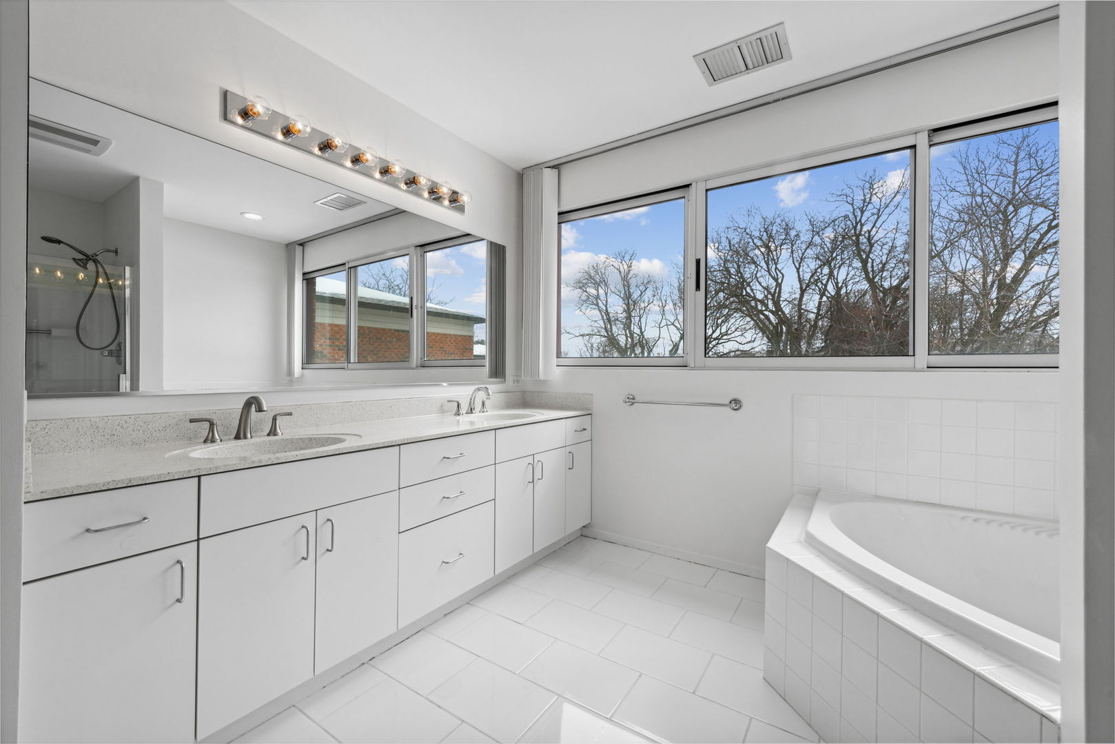 357 Milford Road Deerfield, IL 60015 - Photo 17 of 31 a bathroom with a granite countertop sink mirror and a large window