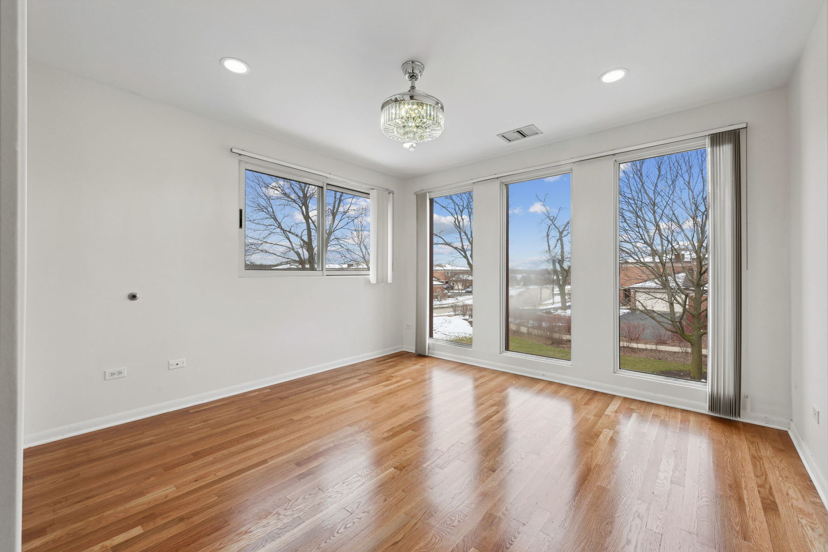 357 Milford Road Deerfield, IL 60015 - Photo 19 of 31 a view of an empty room with a window and wooden floor