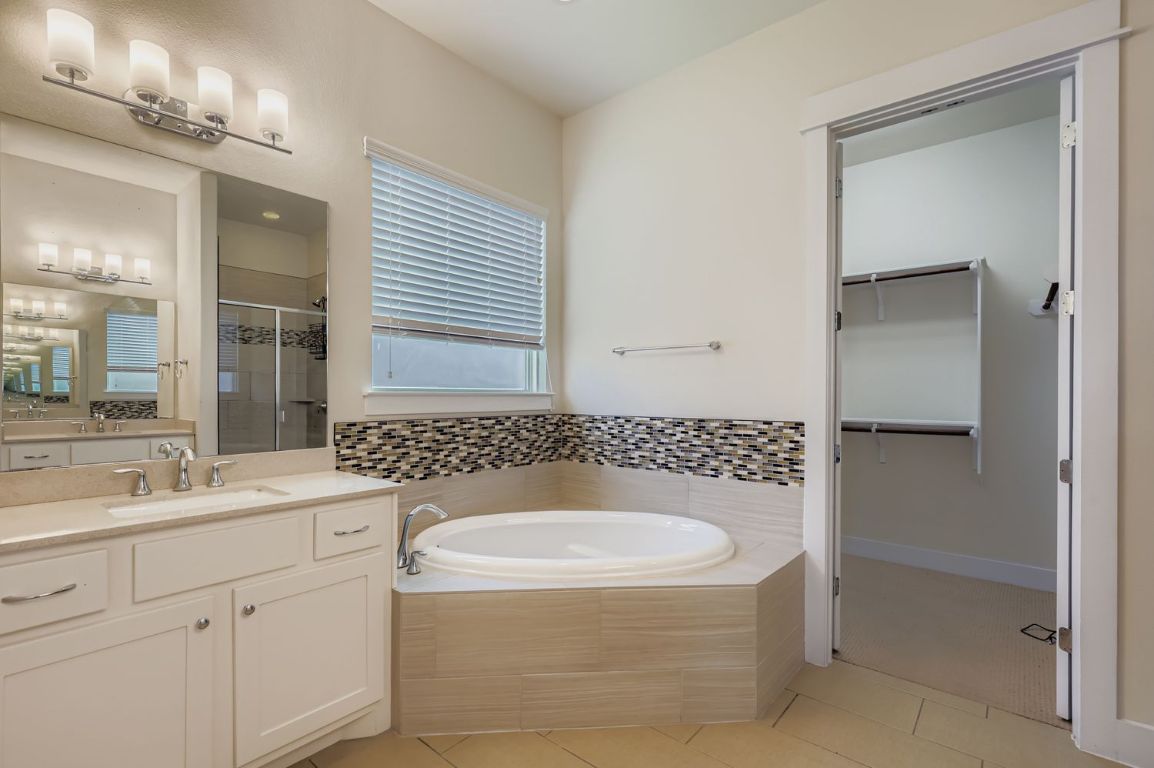 13116 Wingate Way Austin, TX 78727 - Photo 17 of 26 a bathroom with a sink a toilet and shower