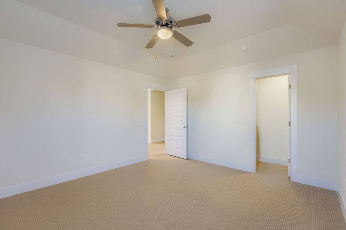 13116 Wingate Way Austin, TX 78727 - Photo 19 of 26 an empty room with a ceiling fan and a ceiling fan