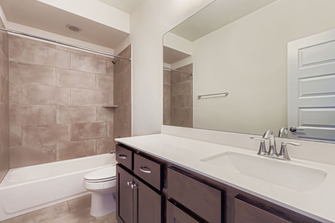 13116 Wingate Way Austin, TX 78727 - Photo 20 of 26 a bathroom with a sink a toilet and shower