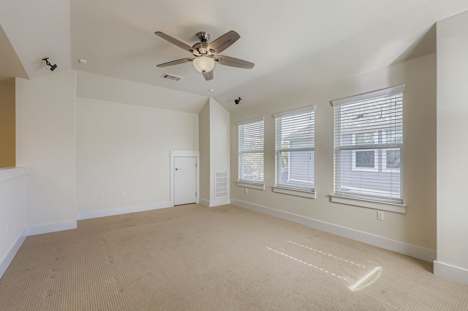 13116 Wingate Way Austin, TX 78727 - Photo 21 of 26 Empty room featuring carpet, a ceiling fan, and vaulted ceiling