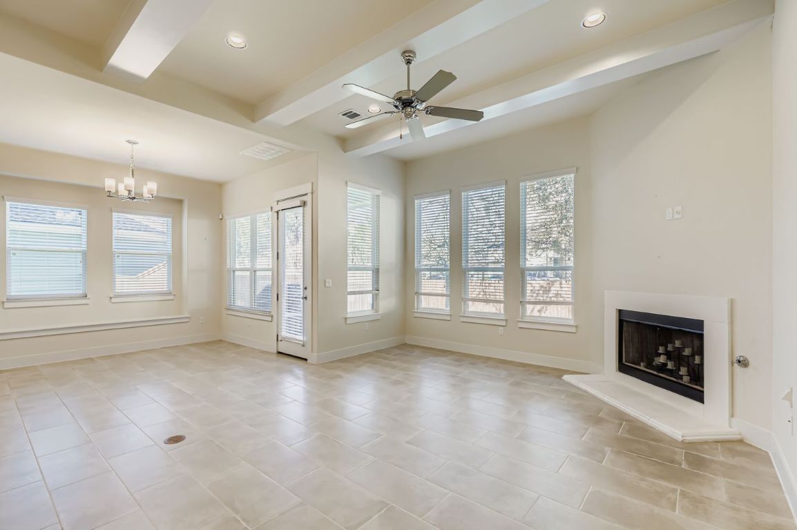13116 Wingate Way Austin, TX 78727 - Photo 5 of 26 a view of an empty room with a fireplace and a window