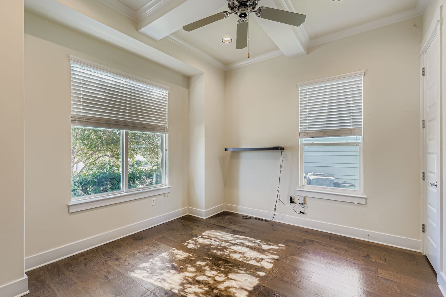 13116 Wingate Way Austin, TX 78727 - Photo 7 of 26 Spare room featuring dark wood-type flooring, ornamental molding, beamed ceiling, ceiling fan, and recessed lighting