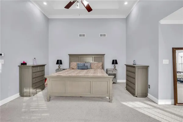 a bedroom with a bed and cabinets