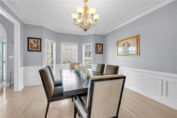 a view of a dining room with furniture and chandelier