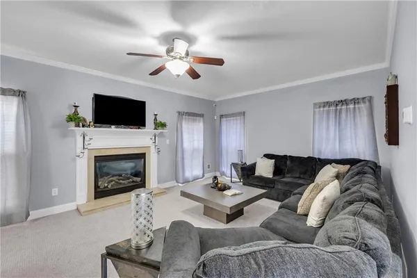 a living room with furniture a fireplace and a flat screen tv
