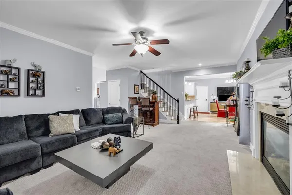 a living room with furniture and kitchen view