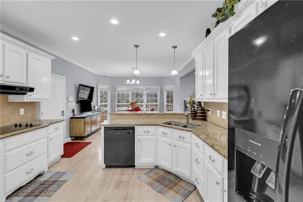 a large kitchen with stainless steel appliances kitchen island granite countertop a sink and cabinets