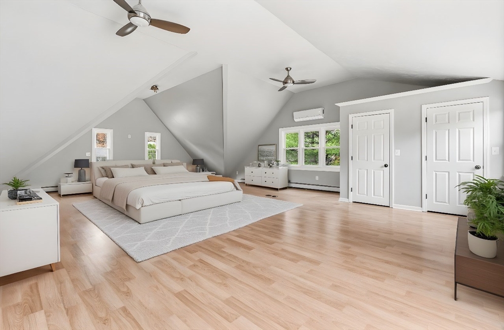 17 Colonial Drive Mendon, MA 01756 - Photo 12 of 42 a spacious bedroom with a large bed and a chandelier