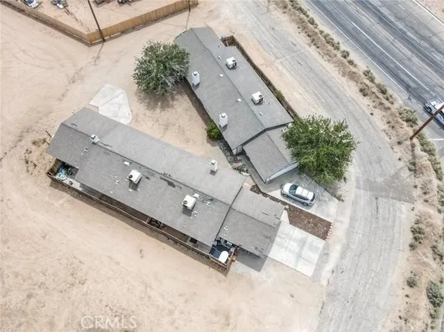 an aerial view of a house with a backyard space and windows