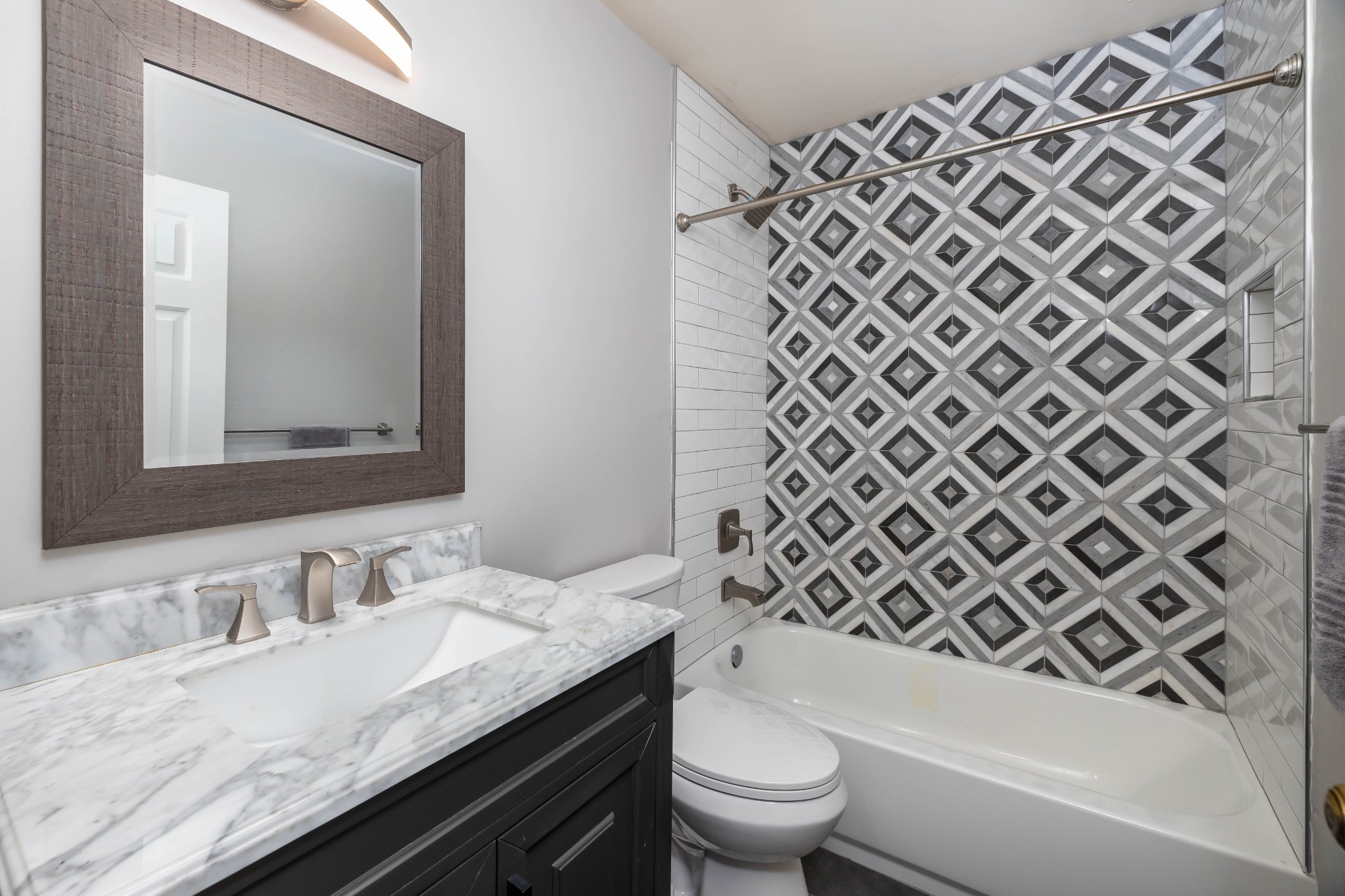 1002 Holly Tree Gap Road Brentwood, TN 37027 - Photo 11 of 27 a bathroom with a granite countertop sink a toilet a mirror and shower