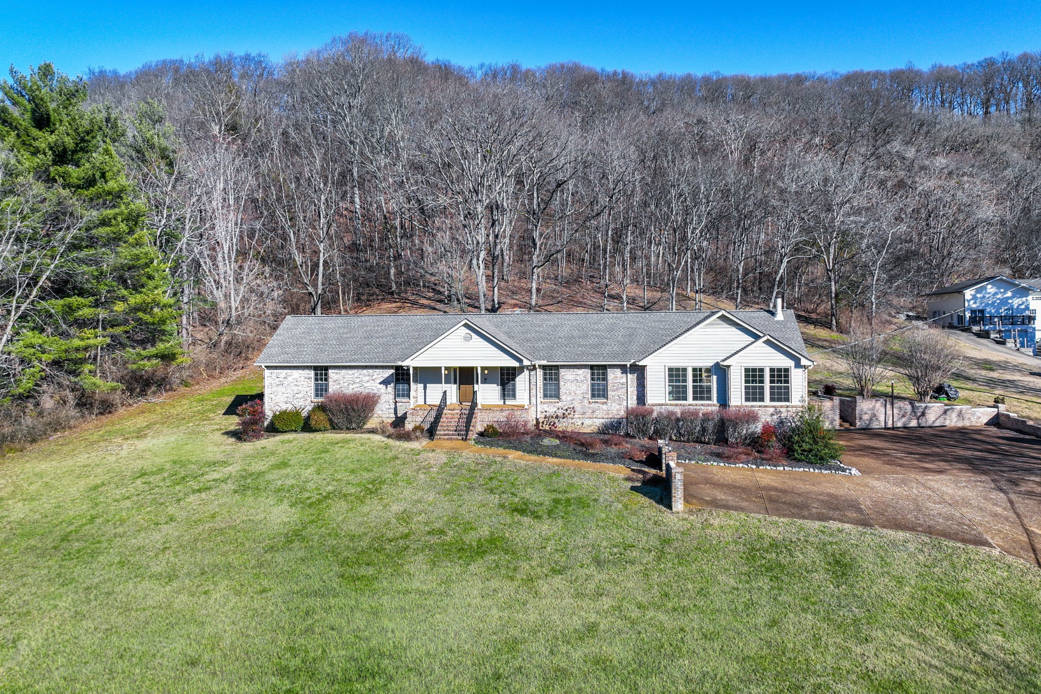 1002 Holly Tree Gap Road Brentwood, TN 37027 - Photo 2 of 27 an aerial view of a house with table and chairs under an umbrella