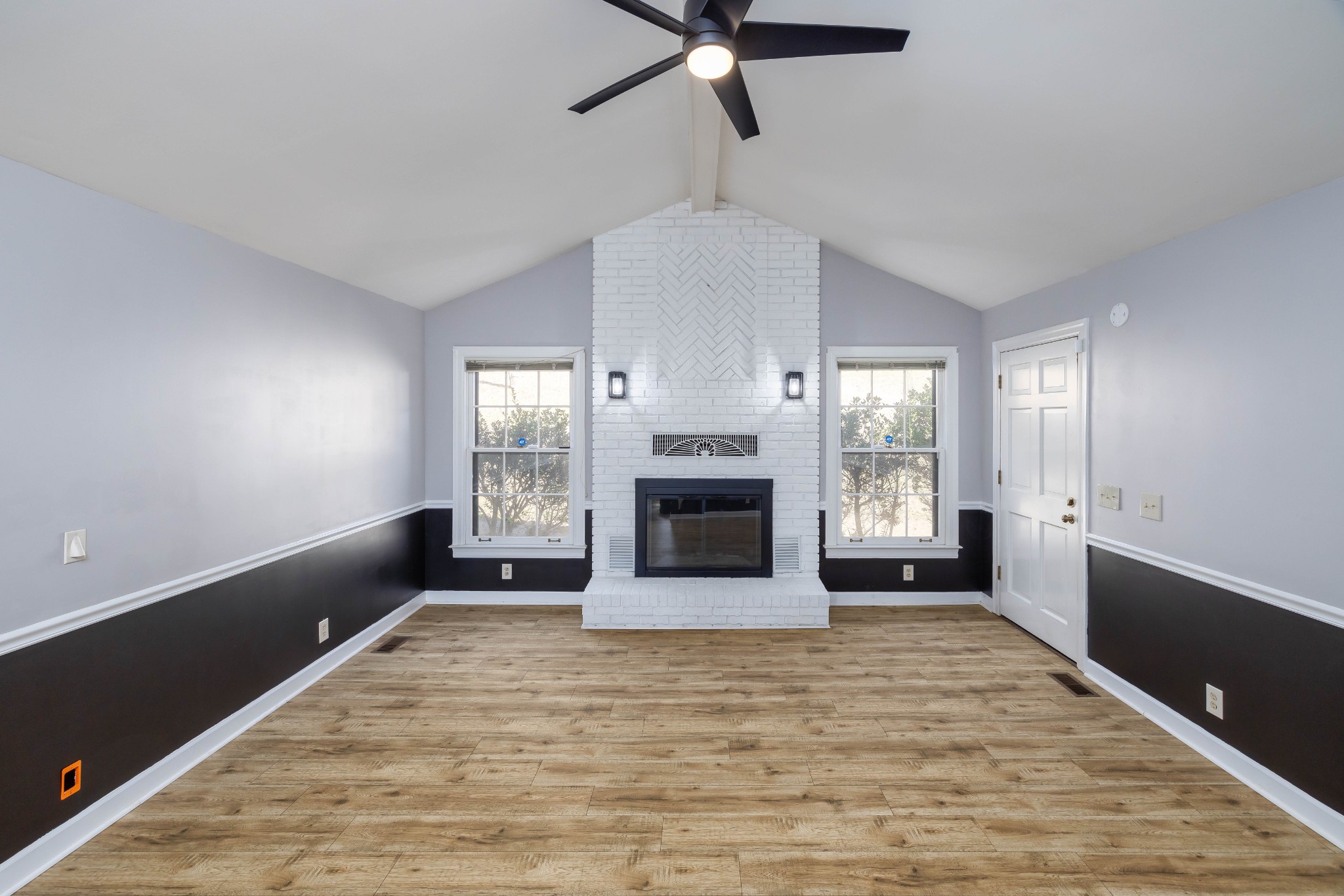 1002 Holly Tree Gap Road Brentwood, TN 37027 - Photo 4 of 27 a view of an empty room with a fireplace and window