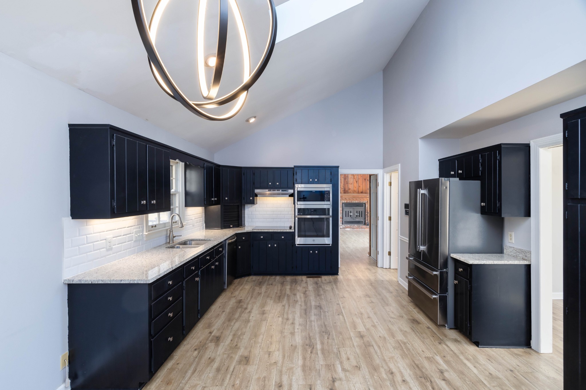 1002 Holly Tree Gap Road Brentwood, TN 37027 - Photo 5 of 27 a kitchen with stainless steel appliances granite countertop a refrigerator a stove and a sink