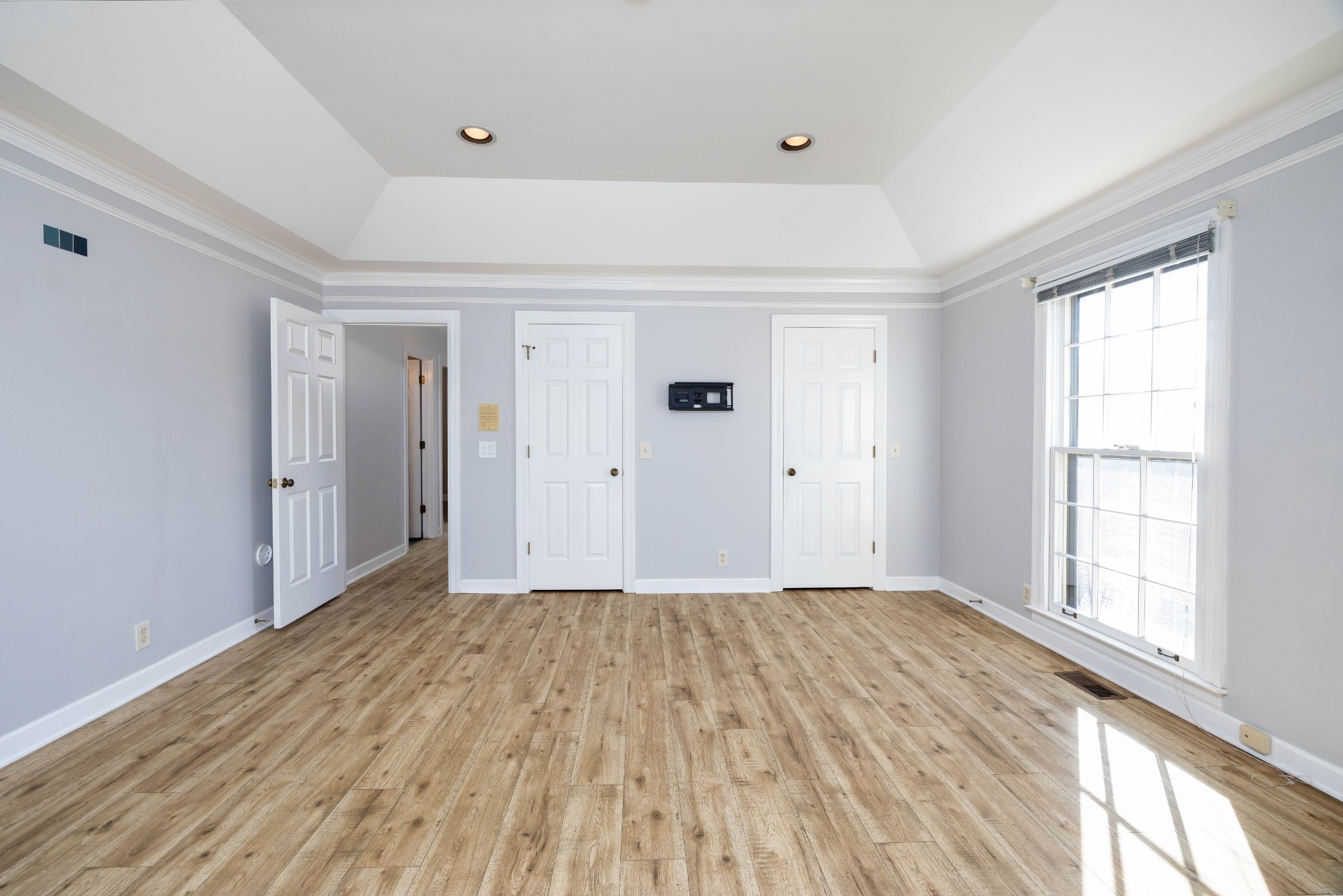 1002 Holly Tree Gap Road Brentwood, TN 37027 - Photo 8 of 27 a view of an empty room with wooden floor and a window