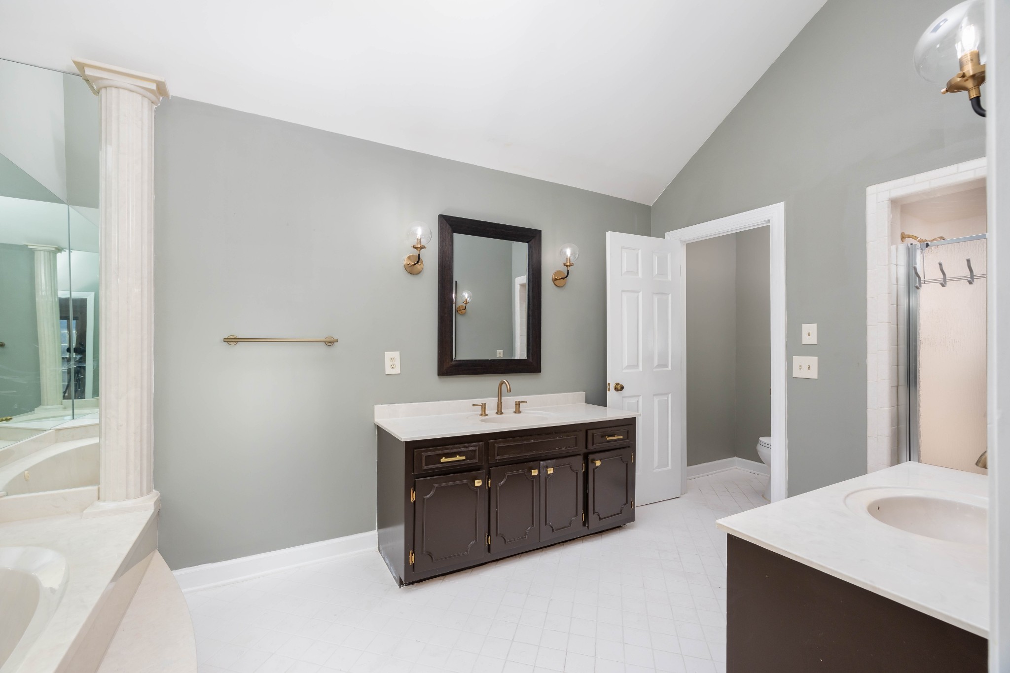 1002 Holly Tree Gap Road Brentwood, TN 37027 - Photo 9 of 27 a bathroom with a tub sink and mirror