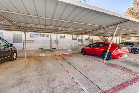 a view of parking garage with cars