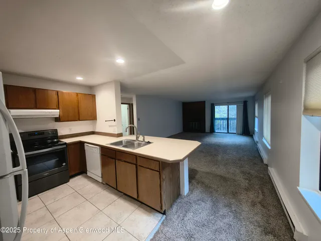 a kitchen with sink cabinets and stainless steel appliances