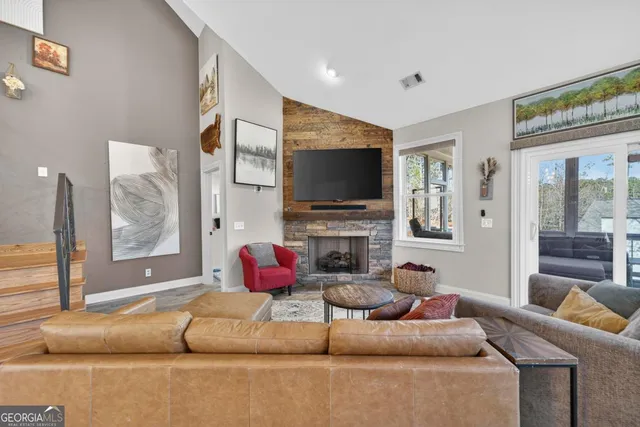 a living room with fireplace furniture and a flat screen tv