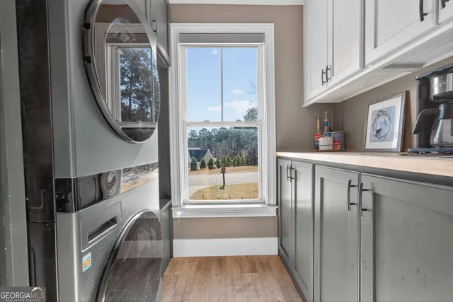 a view of a hallway with wooden floor and entryway