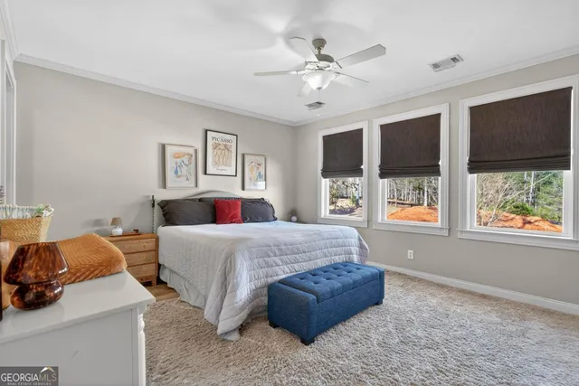 a bedroom with a large bed and a window