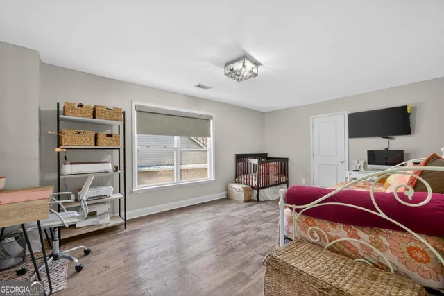 a bed room with a bed and a chair