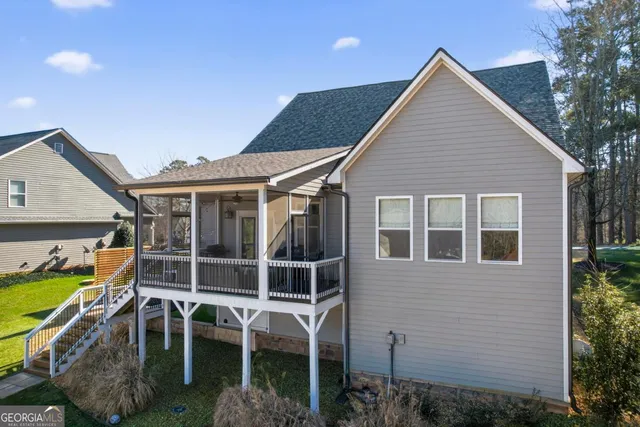 a view of a house with a yard and sitting area