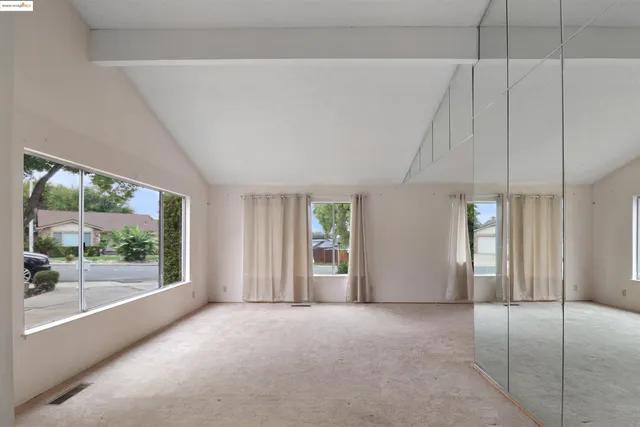 a hallway with windows and chandelier