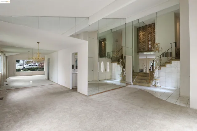a kitchen with white cabinets sink and stove