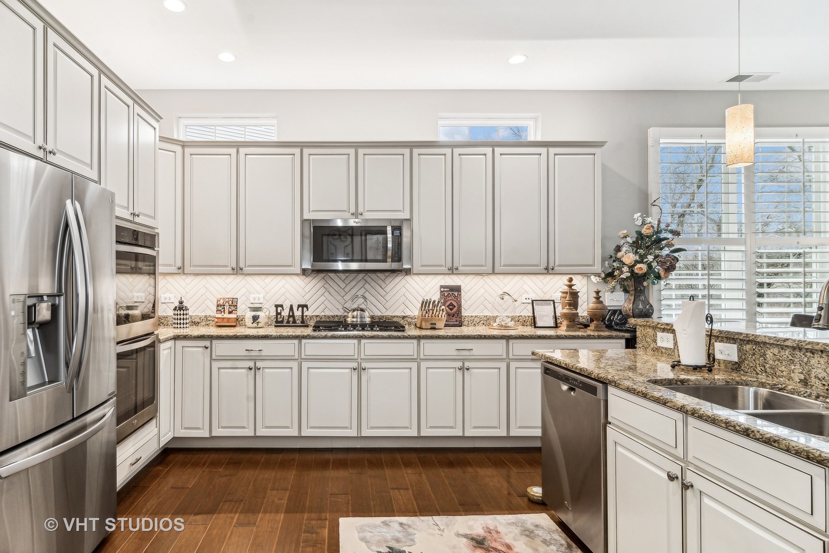 3870 Eagle Ridge Drive Elgin, IL 60124 - Photo 8 of 20 a kitchen with stainless steel appliances granite countertop a sink a stove a refrigerator and cabinets